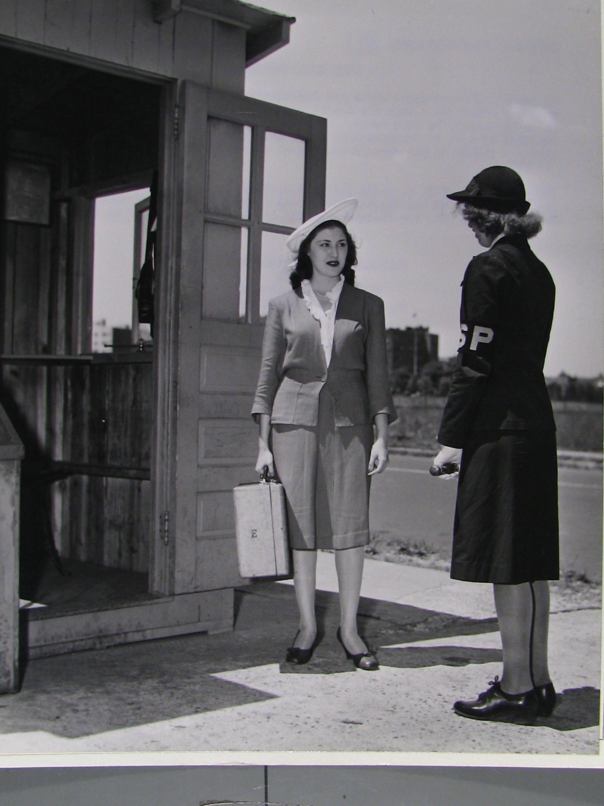 Espinosa in civilian clothes arrives for WAVES training, Hunter College. 